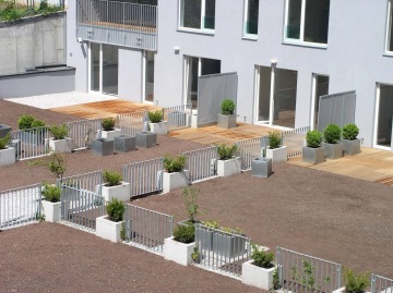 Moderní terasy s květináči a kovovým vnějším zábradlím.