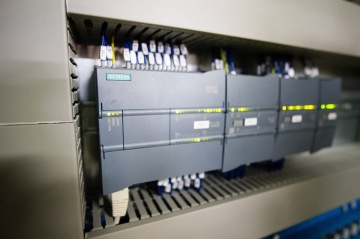 Siemens průmyslový řídicí systém s blikajícími kontrolkami na zařízení.